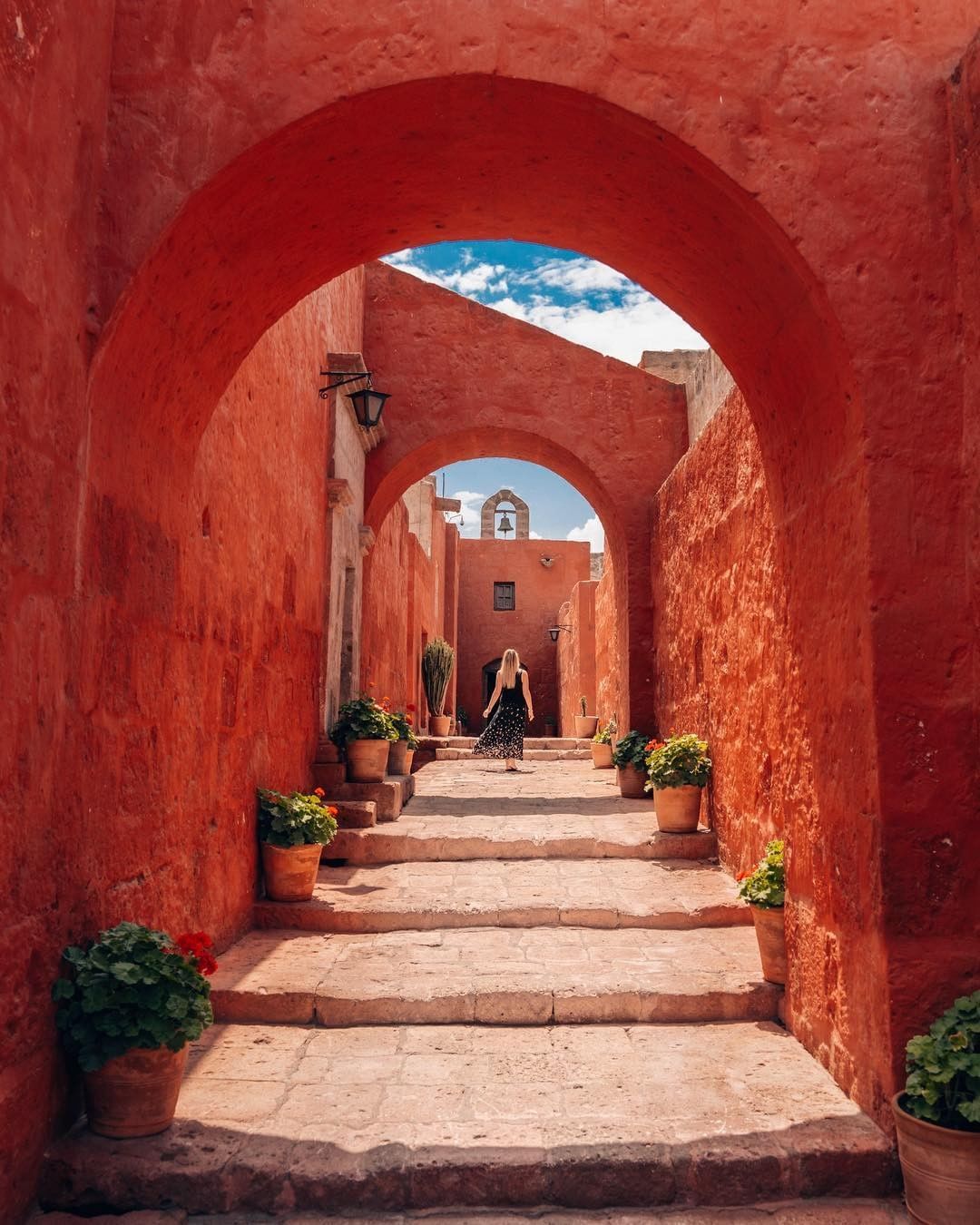 Red stone archway and stepped lane inside Santa Catalina Monastery